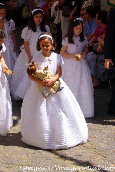 Menina no vestido branco com uma procissão boneca em Toledo - Espanha