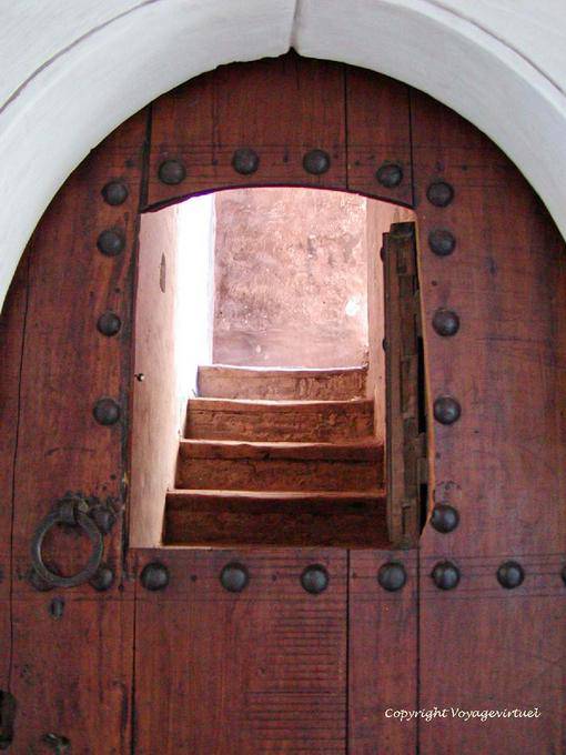 Abertura em uma porta de madeira e escada, Ben Youssef Madrasa, Marrakech - Marrocos