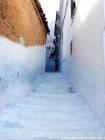 As etapas azuis de uma rua íngreme, Chefchaouen, Marrocos.
